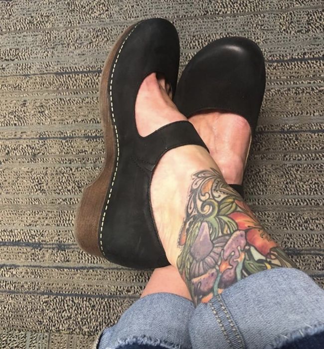 Black clogs featuring brown soles