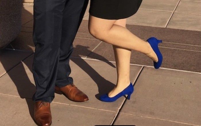 A customer’s photo of her wearing royal blue heels, standing next to her date in oxfords at a wedding