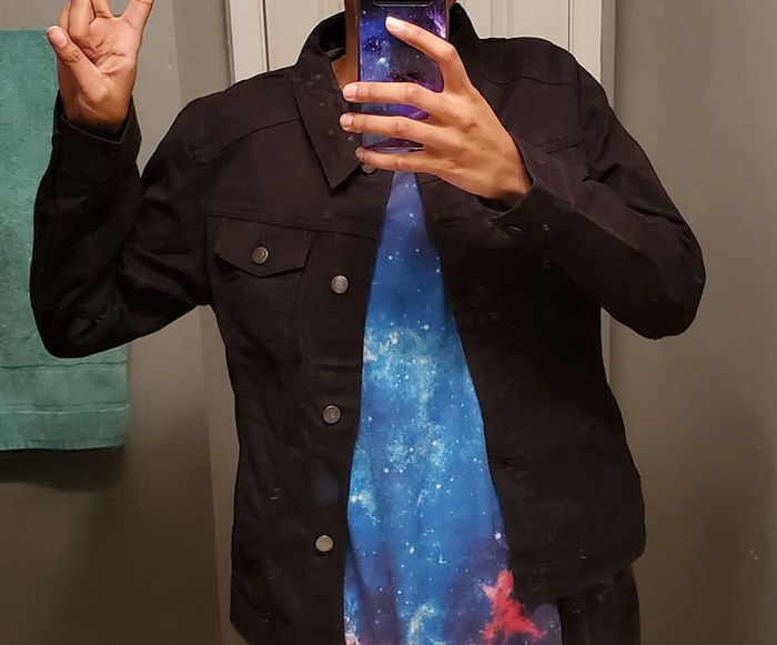 Reviewer showcasing a black denim jacket