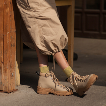 A model wearing the beige shoes