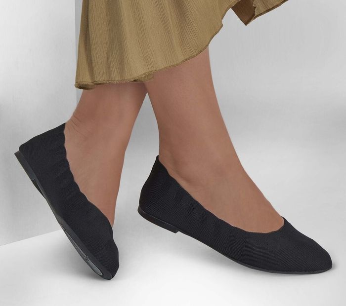 The black flats worn by a model.