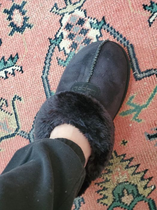 Reviewer styling a black slipper