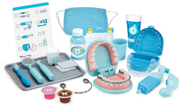 The Melissa & Doug dentist play set includes a variety of fun tools like dental instruments, a mouth model with teeth, dental accessories, toothpaste, a face mask, and a dental chart for an immersive pretend-play experience.