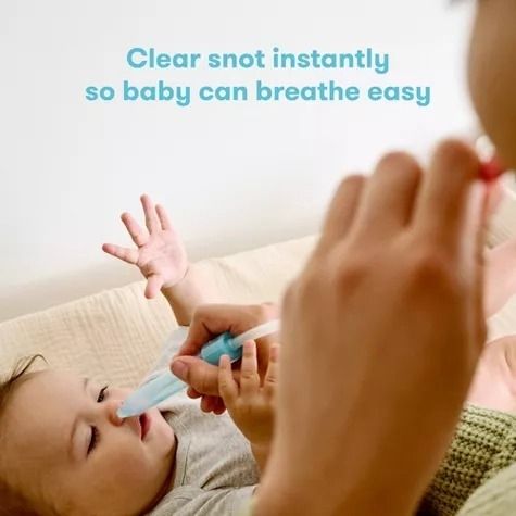 A person using a nasal aspirator on a baby lying down, with text that reads,