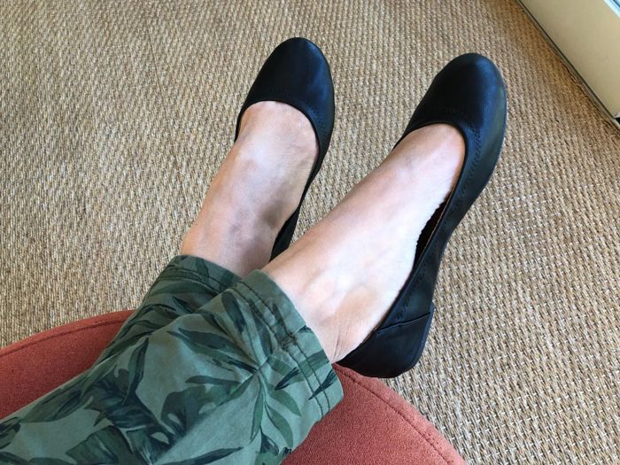 Reviewer wearing black Amazon ballet flats