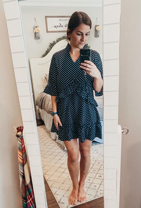 reviewer wearing the black dress with white polka dots