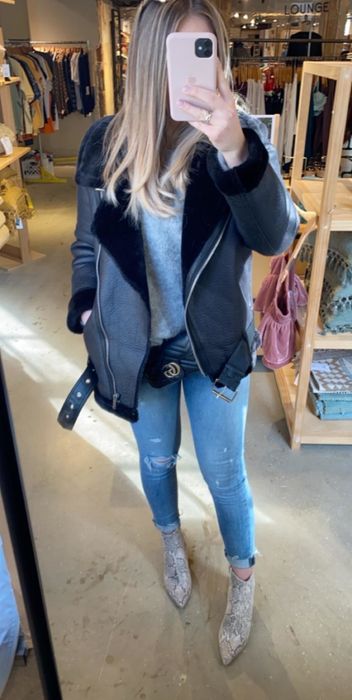 Another reviewer is also wearing the black moto jacket, but with it unzipped in the front.