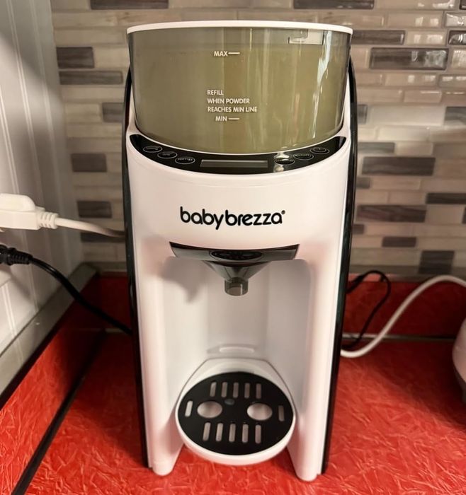 A Baby Brezza device positioned on a kitchen counter, designed for preparing baby formula