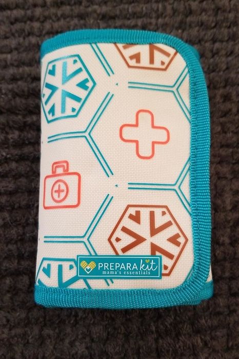 A sleek and compact first-aid kit featuring modern geometric designs and the recognizable PreparaKit logo.