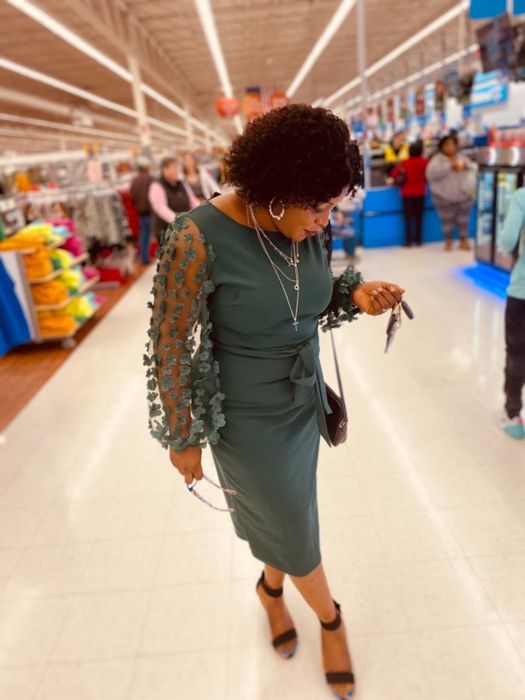 reviewer wearing the green dress