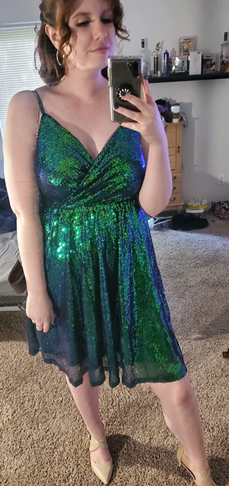 reviewer wearing a green dress