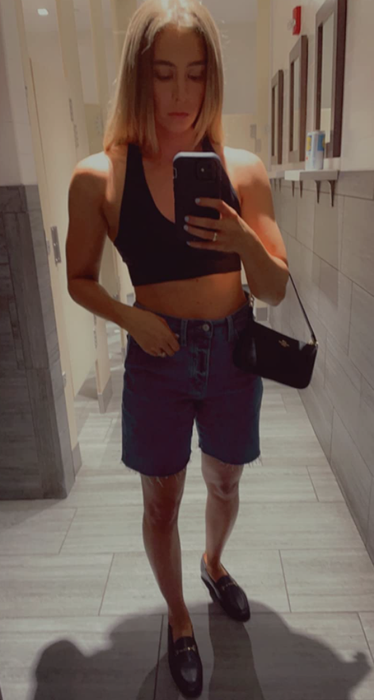 The reviewer is wearing black loafers in a mirror selfie.