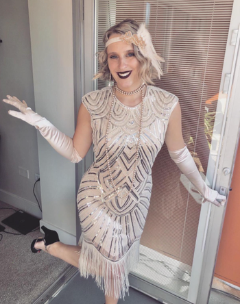 reviewer wearing a dress with '20s-style accessories