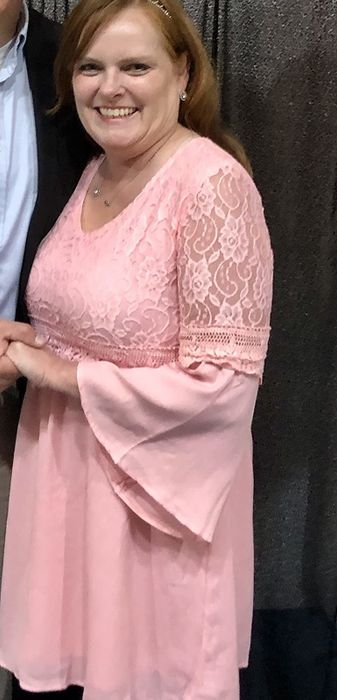 reviewer wearing the pink dress