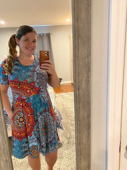 reviewer wearing the dress with blue and orange patterns