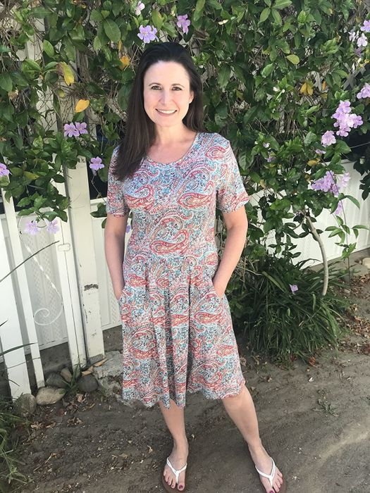 reviewer wearing the dress with pastel patterns