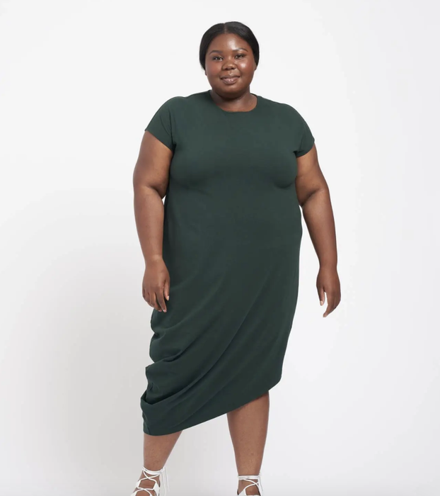 The model is seen wearing a stylish green dress.