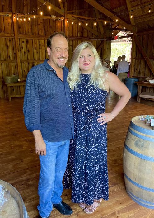 reviewer wearing the blue dress posing with another person
