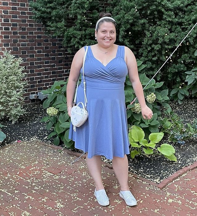 reviewer wearing the blue dress