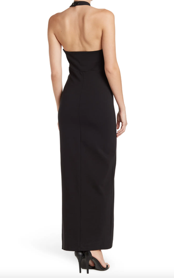 model showcasing the back view of the black dress