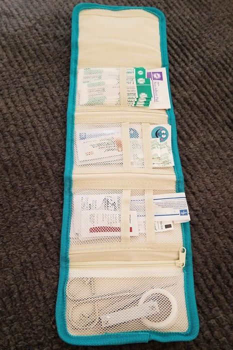 A travel organizer with multiple compartments, some designed to hold cards and travel-sized essentials, making it easy to stay organized on the go.