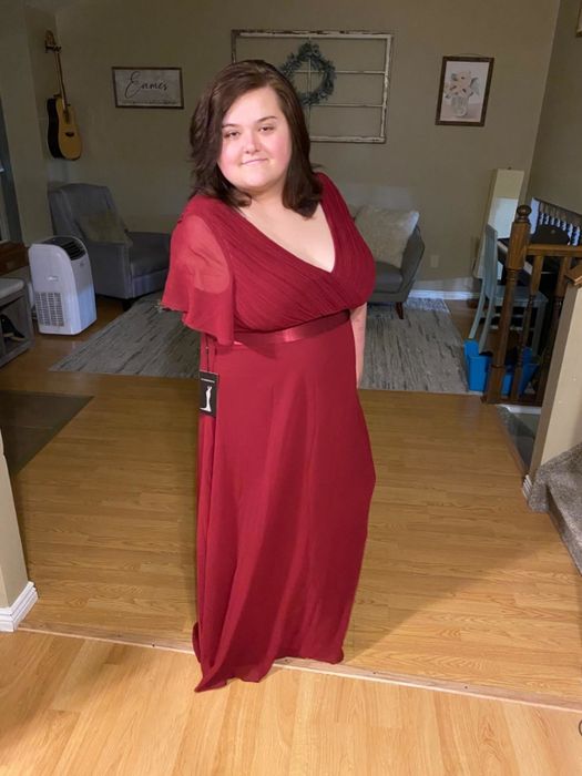 reviewer wearing the red dress