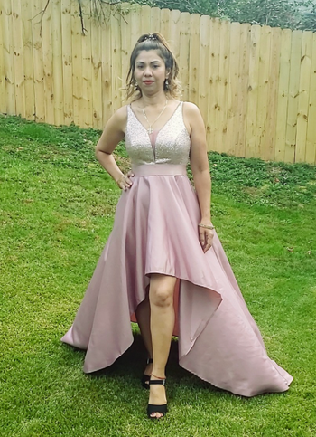 reviewer wearing an orchid-colored dress in the grass