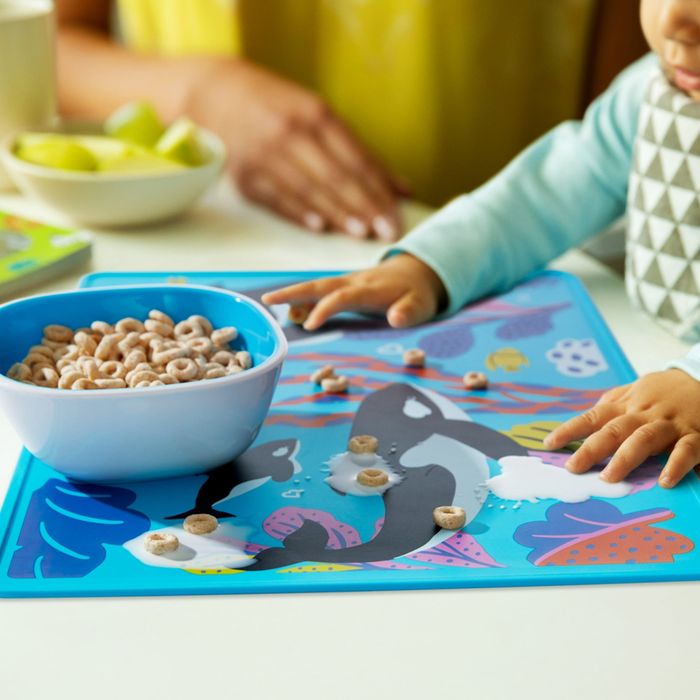 A bowl placed on a whale-shaped silicone placemat