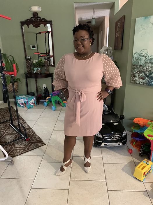 reviewer wearing the pink dress
