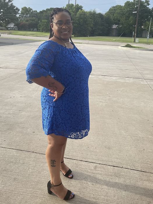 reviewer wearing the blue dress with black heels