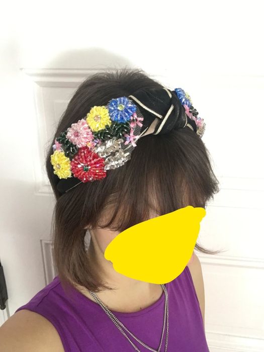 The reviewer is wearing the black headband, showcasing how it looks when worn.