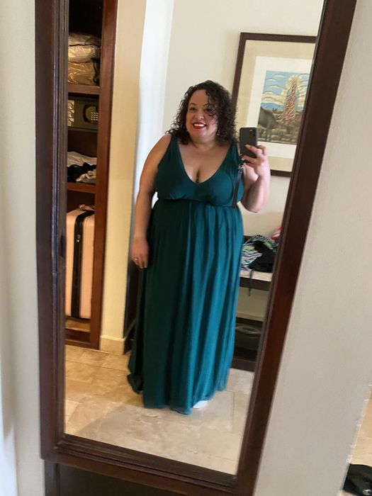 reviewer wearing the green dress