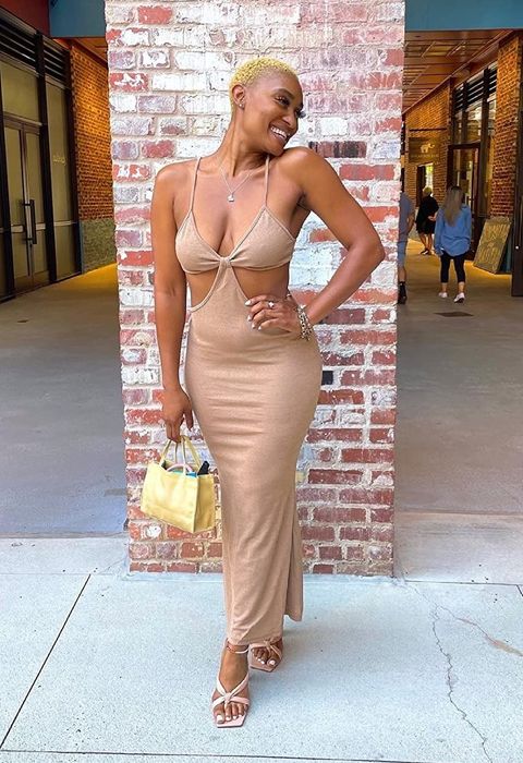 The reviewer is wearing a tan-colored dress.