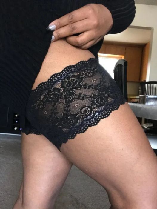 A reviewer is pictured wearing the black lace thigh bands
