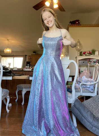 reviewer wearing a grey-blue dress