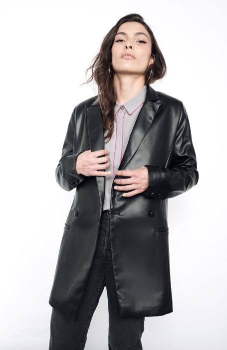 The model is wearing the sleek faux leather blazer.