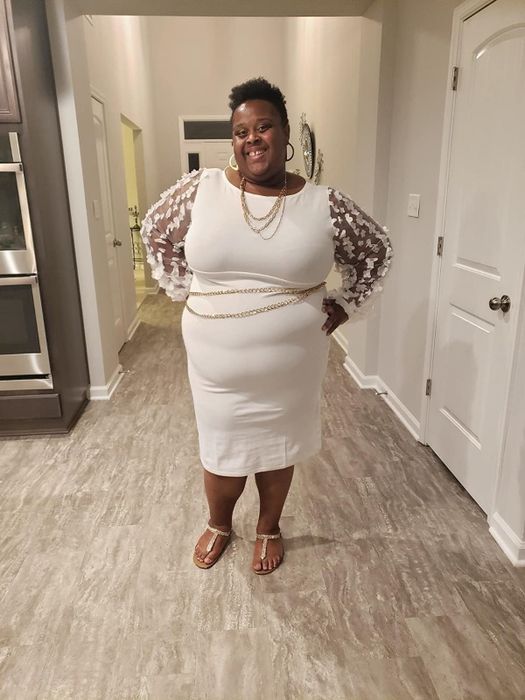 The reviewer is dressed in a white dress.