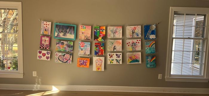 A collection of colorful children’s artwork proudly displayed on a wall, turning a room into an ever-evolving gallery.