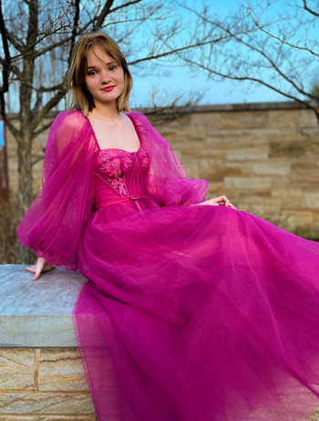 reviewer wearing a magenta tulle ball gown
