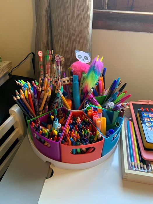 A tidy stationary holder packed with colored pencils, markers, scissors, and notebooks, neatly arranged on a desk for easy access and creative inspiration.