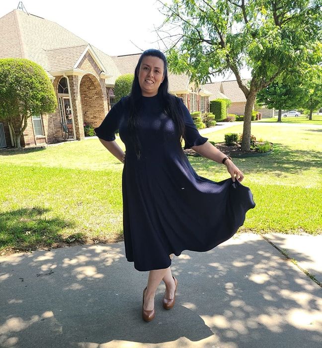 reviewer wearing the black dress