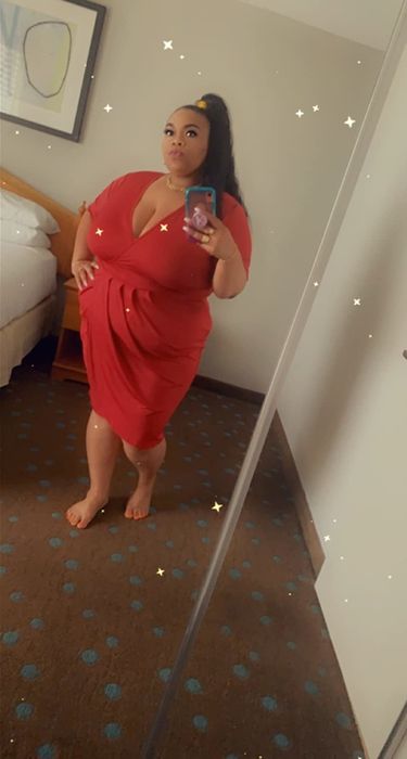 reviewer wearing the red dress