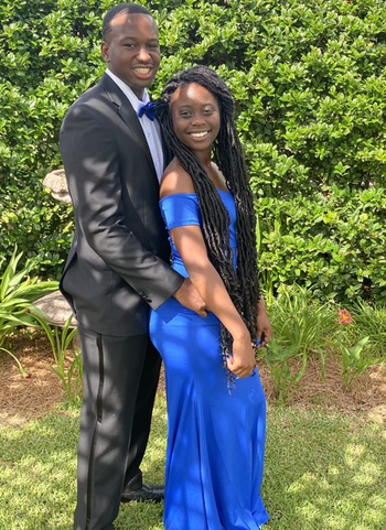 reviewer wearing a blue dress with date