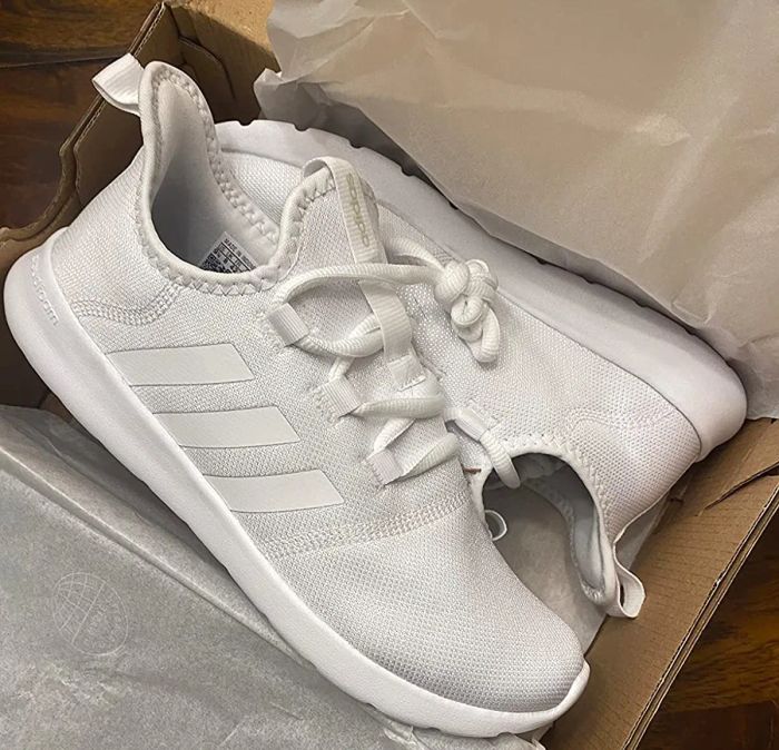 A reviewer shares a photo of the white sneakers inside a shoebox