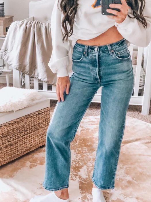 A reviewer rocking the jeans in medium indigo.