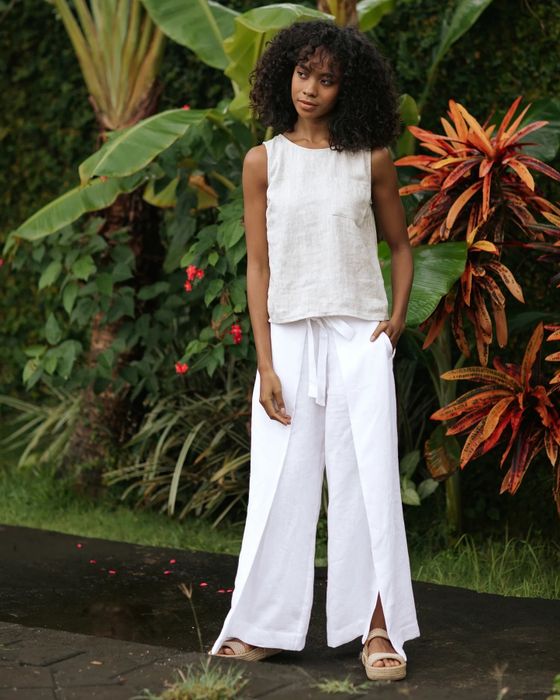 A model is shown wearing white pants paired with a white top and matching footwear.