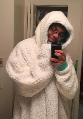 a reviewer wearing the cozy white blanket sweatshirt