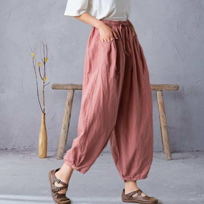 A model is shown wearing the pink pants.