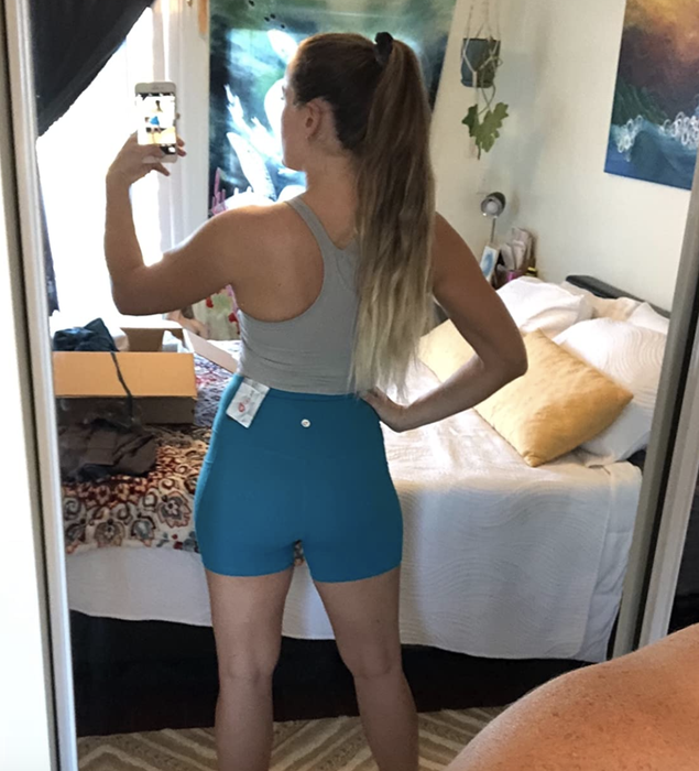 reviewer wearing the blue shorts