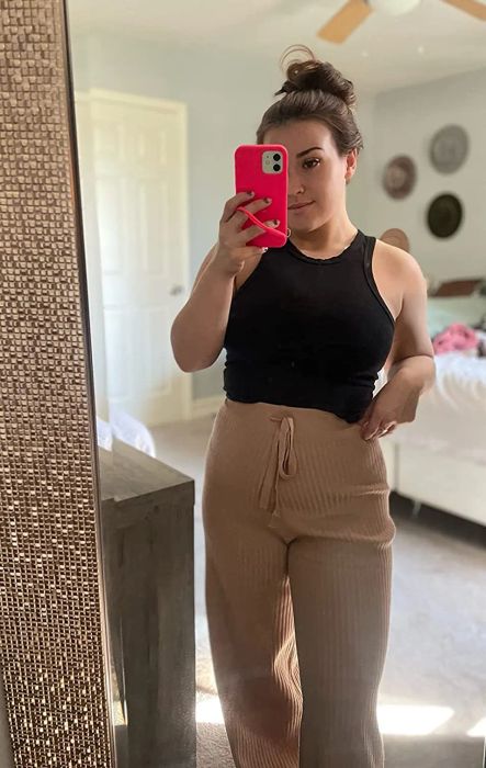 another reviewer wearing khaki sweater pants